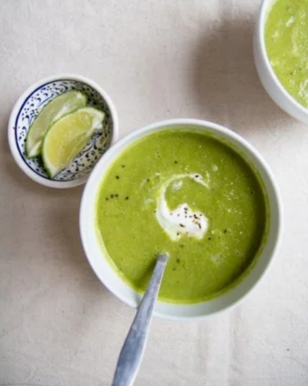 Pea and pesto soup with lime wedges