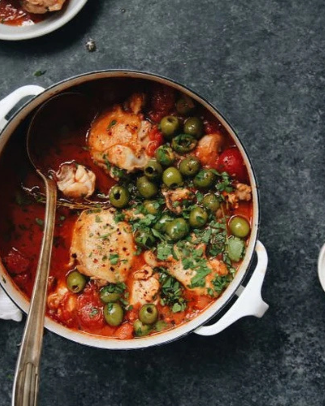 Stewed dish with chicken, olives, and tomatoes